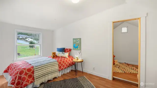 Another view of the upstairs guest bedroom with a sizable walk-in closet.