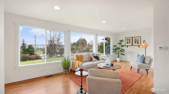 Take in these stunning valley & Olympic Mountain views as light pours into the living room.