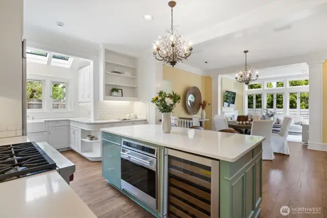 Upscale kitchen ready for the most discerning chef. Dreamy layout with casual eating, island seating, sunny sitting room in the background and abundant windows letting in light all day.