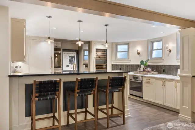 Lower level full kitchen with quartz counters, Brizo faucet, and  Sub Zero wine cabinet.