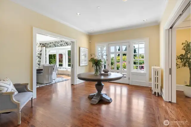 The original front door overlooks perfectly manicured verdant gardens and a private front porch