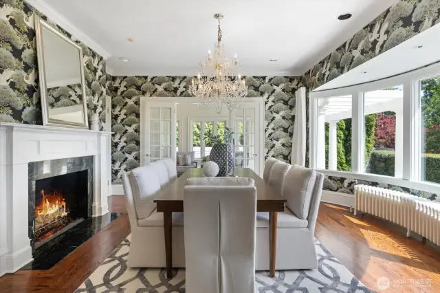 Designer dining room can accommodate an oversized table. An additional fireplace for comfort and bow windows to highlight the scenery.