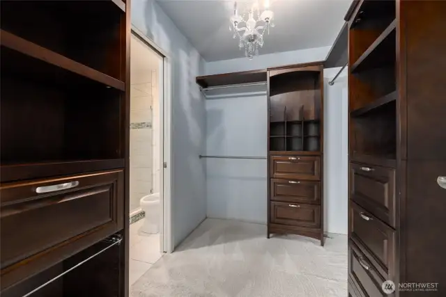 Primary bedroom has a walk in closet with custom shelving.