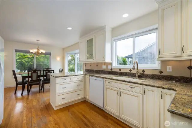 Kitchen is open to the dining room with large windows and a sliding glass door that takes out out to the patio and deck.