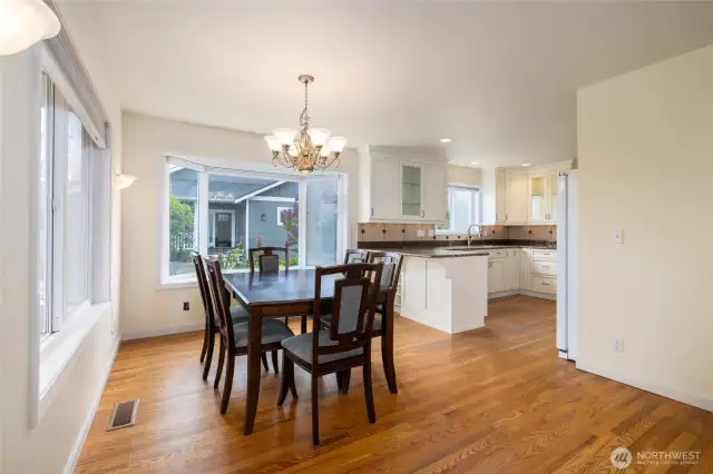 Dining room and kitchen, beautiful hardwood floors.