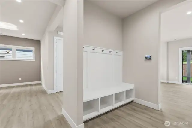 Functional built-in mudroom with bench seating, cubby storage, and coat hooks—perfect for everyday organization. Located just off the garage entry, this space blends convenience with thoughtful design.
