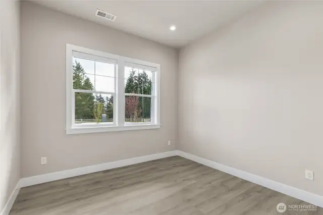 Flexible main-level room with large window, recessed lighting, and durable wide-plank flooring—ideal for a home office, guest room, or study. Neutral tones make it easy to personalize.