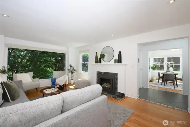 The living room is larger than many for homes of this scale. It’s a restorative retreat with a formal central gas fireplace, sight lines through to the dining room and a rich textured landscaped outlook to the established gardens.
