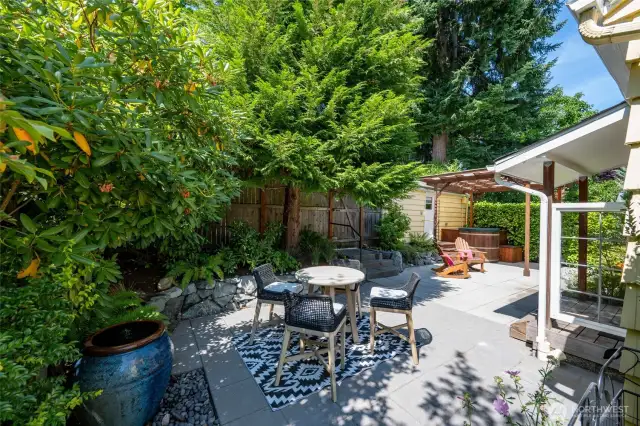 Backyard hardscape architecture by Greener Living Solutions and Joanna D’Asaro Landscape Architect. It is a sanctuary with permeable paving, a spot lit water feature and includes a covered cedar hot tub.