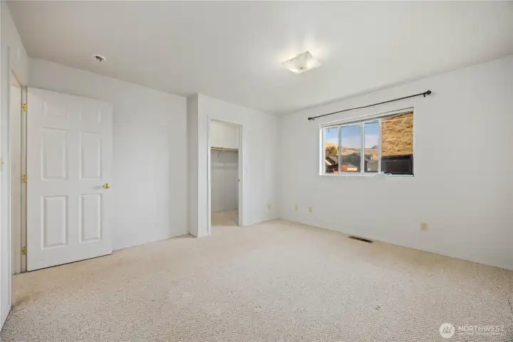 Primary bedroom with walk-in closet