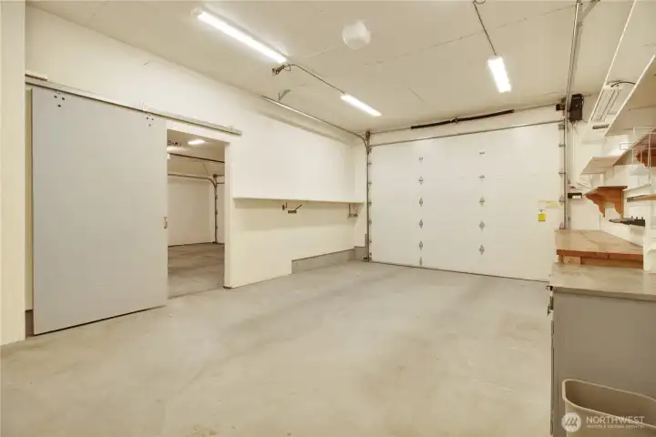 Oversized garage bay with shelving for storage, 10 ft door and opener.  Lots of lighting!
