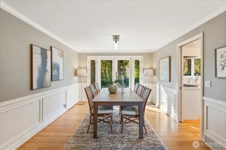 Adjacent to the updated kitchen, the light-filled dining room features French doors to the backyard for seamless indoor-outdoor entertaining.