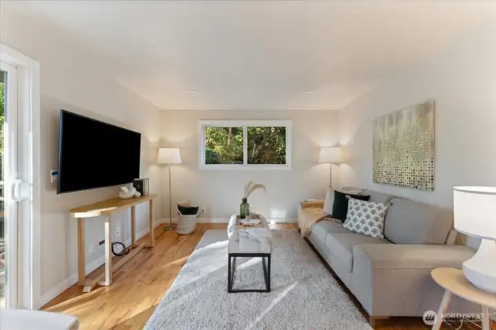 Adjacent to the eat-in kitchen, a versatile hangout area enjoys sliding doors to the patio and ample natural light.