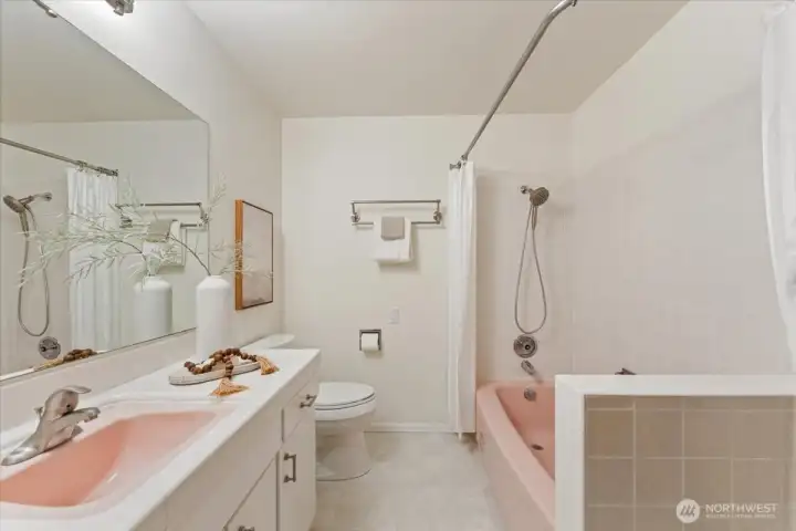 Upper-level full bathroom features beautifully preserved mid-century details and timeless charm.