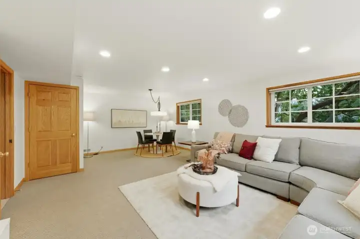 Enormous lower-level rec room offers multiple zones—space for a full sectional to enjoy TV and media, a separate table space for play or study, as well as generous storage space.