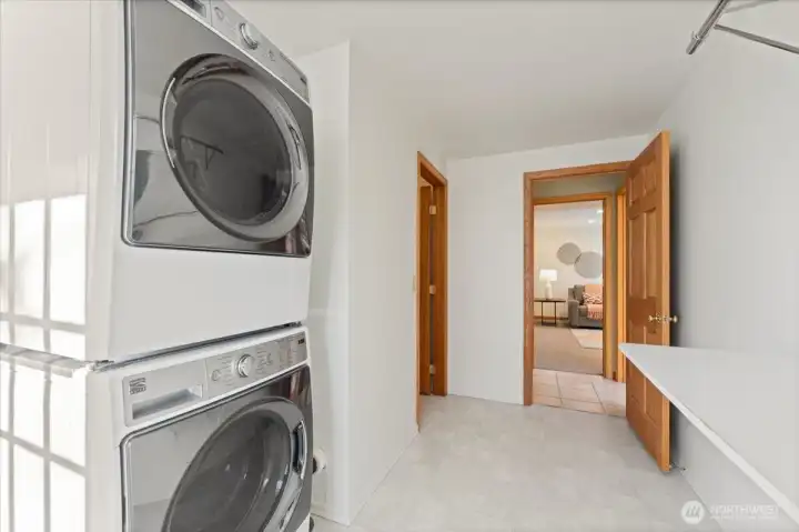 Generously sized utility room with newer washer and dryer.