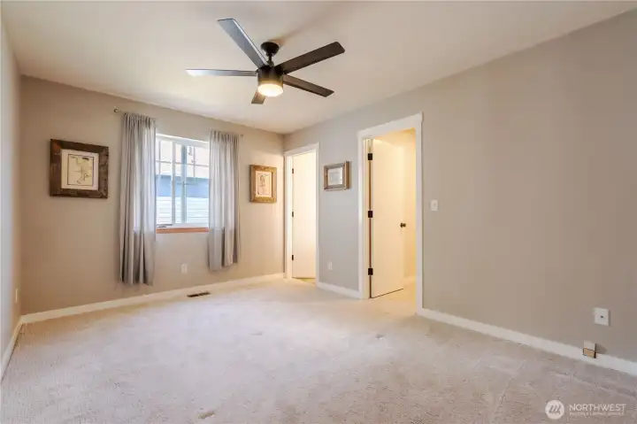 Primary bedroom with primary bath and walk-in closet.