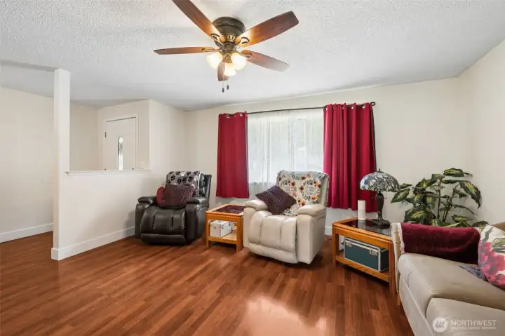 Welcoming main living area with ceiling fan and comfortable layout.