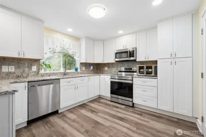 Remodeled kitchen with soft close cabinets, ample-counter space, and modern finishes.