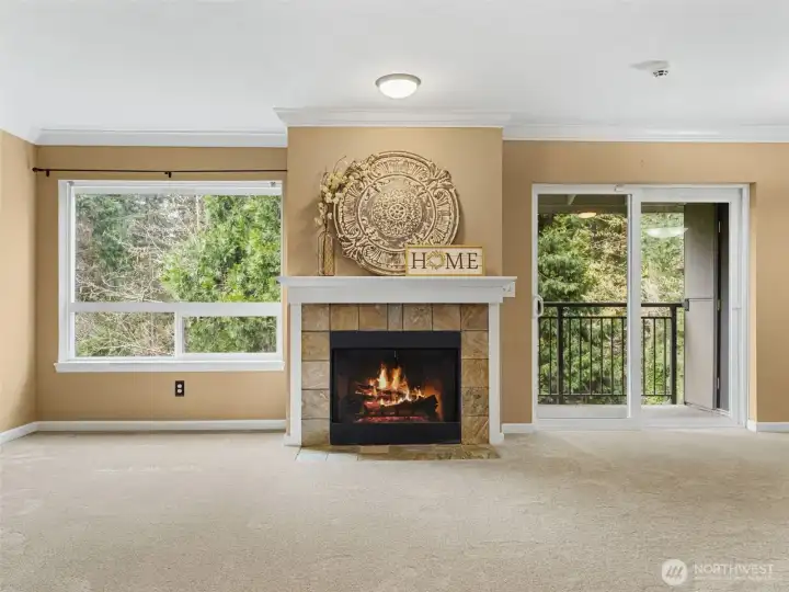 A warm & welcoming living space with wood-burning fireplace and brand-new carpet.
