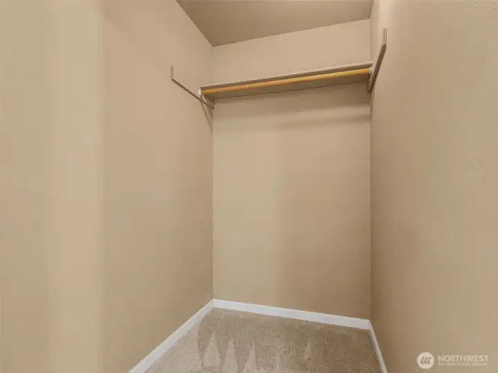 Another view of the walk-in closet where there is room to add more rods or shelves.