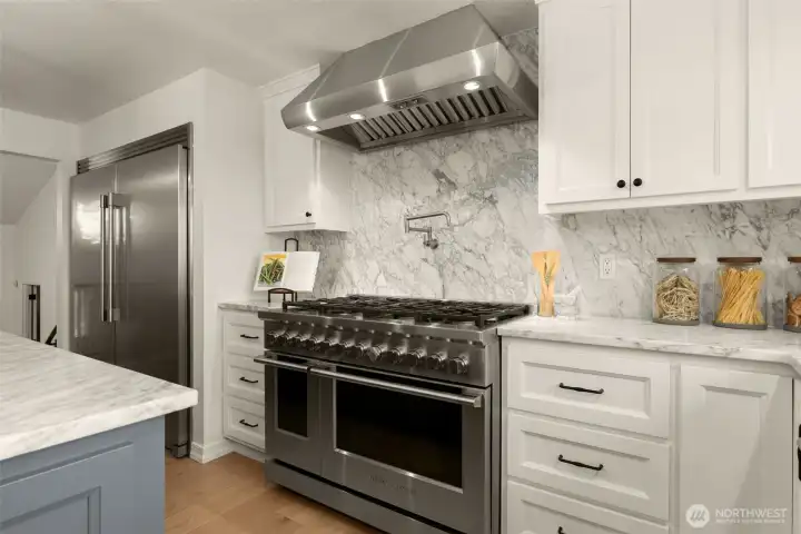 Full size freezer & refrigerator, 12 natural gas burners in all with island cooktop, pot filler, Fisher & Paykel double oven.