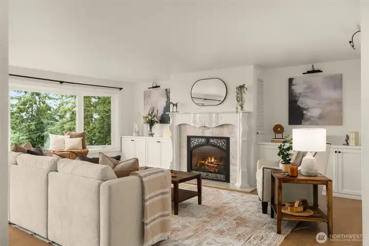 Formal living room w/natural gas fireplace, custom mantel, framed by built in cabinetry & shelving.