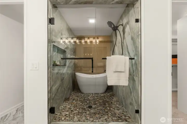 Spa-inspired primary bath en suite with free-standing tub perfectly nestled within the shower surround, magazine worthy.