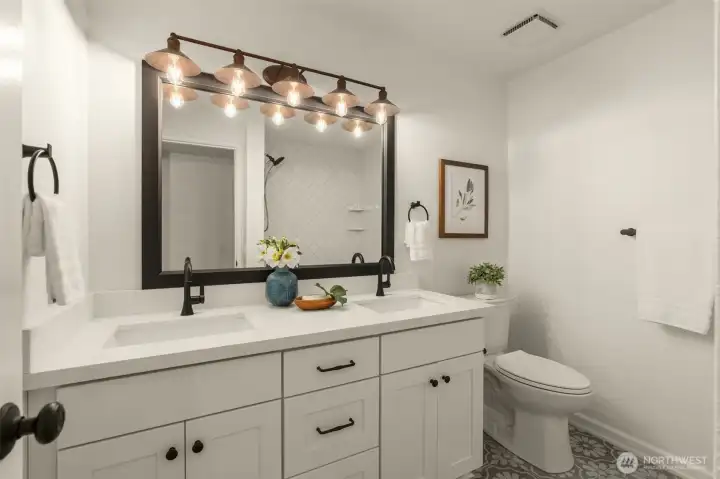 Stylish updated lower level full bathroom. Dual sink vanity, memorable hardware, tile with interest. Personality A+!