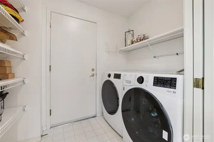 Side by side Washer and Dryer and a pantry with door to garage