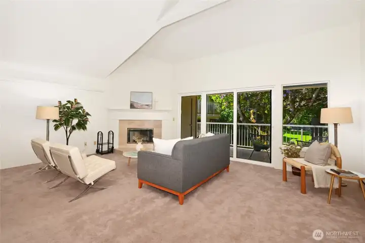 Expansive living room, with a wood-burning fireplace and vaulted ceilings.