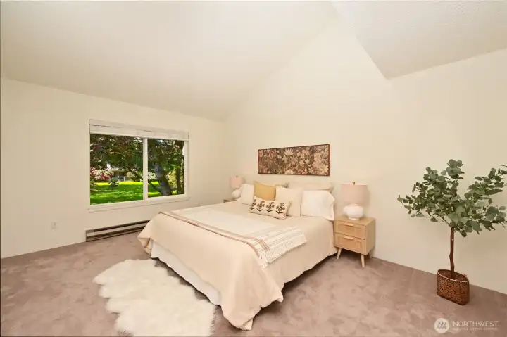 Primary Suite includes room for a king size bed, trees and a wall of closets!