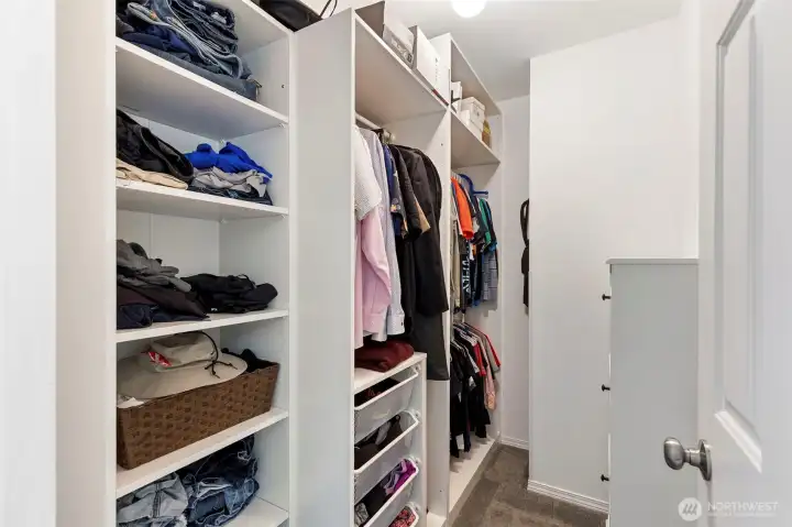 Spacious walk-in closet with organizer shelves!