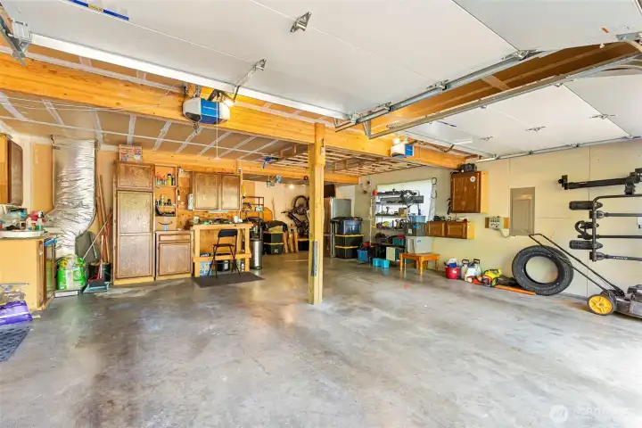 In the back of the garage you will find a spacious workshop area with lots of shelving and room for woodworking or any hobby.