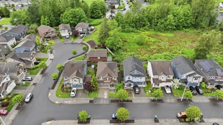 This view shows the greenbelt area.  There is also a shared common area at the end and to the right of the cul-de-sac