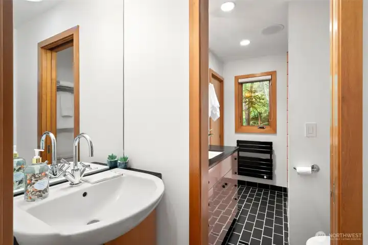 Hallway 1/2 bath connects to the full bath off the second bedroom.