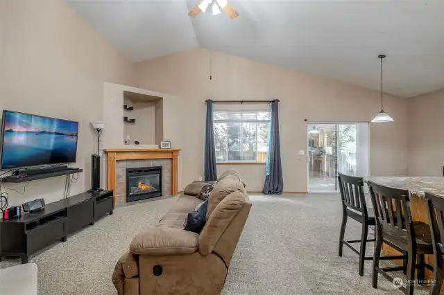 Large Family Room with cozy fireplace off kitchen