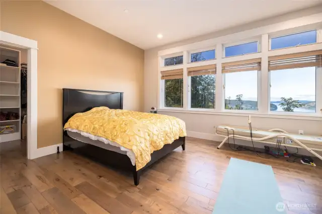 Primary suite has a wall of windows to take advantage of the view.