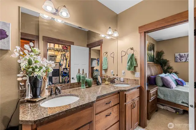 Primary en suite features walk-in closet as seen reflected in mirror