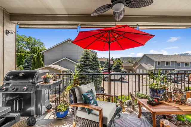 Lovely outdoor balcony with natural gas BBQ and sunshades that are included in sale.
