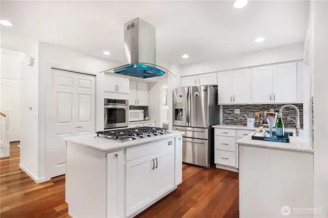 Open kitchen with new cooktop and new overhead range