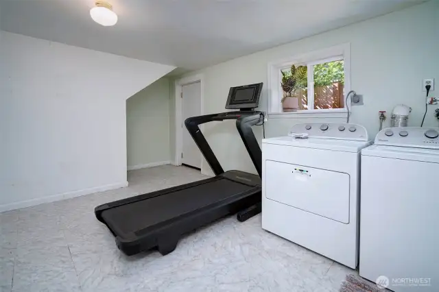 Lower level family room with separate access. Previously used as TV room. In addition, there is a bonus room that could be an amazing designated laundry room and garage access.