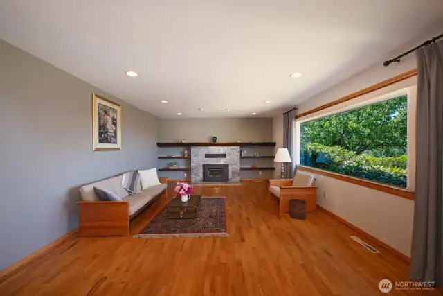 Living room with gas fireplace and large window to take in the view.