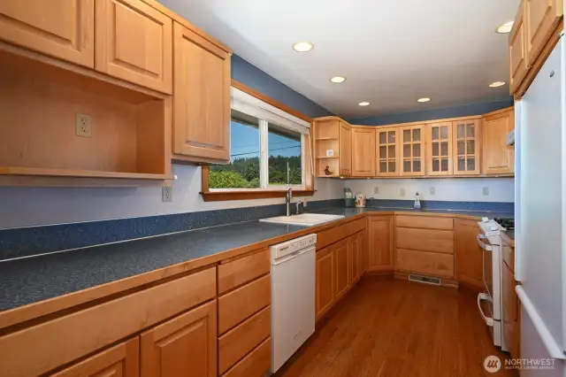Remodeled kitchen with plenty of cabinets. There is a pantry out of view off the hallway.