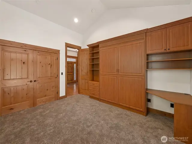 A versatile space designed for productivity and rest — custom wood cabinetry, built-in shelving, and a hidden Murphy bed make this an ideal office by day and private guest suite when needed. Access to its own patio creates seamless indoor-outdoor flow.