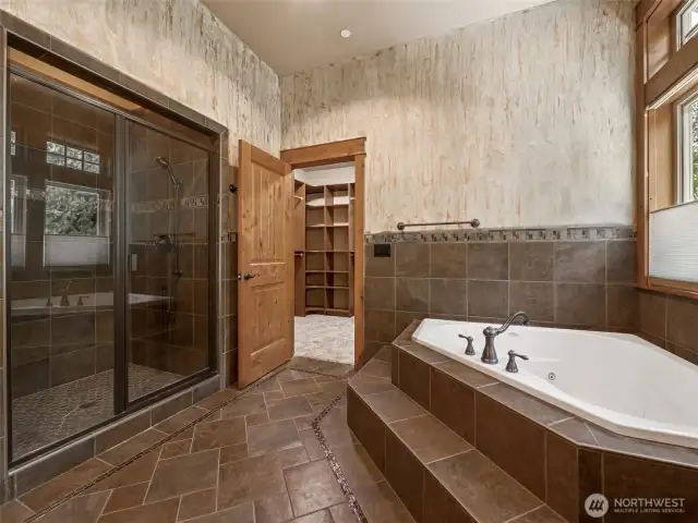 Tucked beneath large view windows with top-down privacy shades, the deep jetted soaking tub is surrounded by tile and finished with designer hardware. The perfect place to relax after a day on the trails or the golf course.