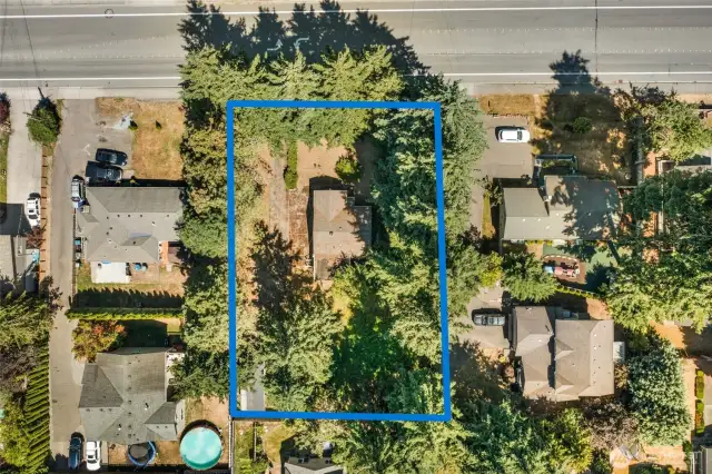 Birdseye view - 16,117 sq ft buildable lot opportunity - looking East to West at lot - property abuts 148th on the North boundary with two dozen Ponderosa Pines bordering the property.