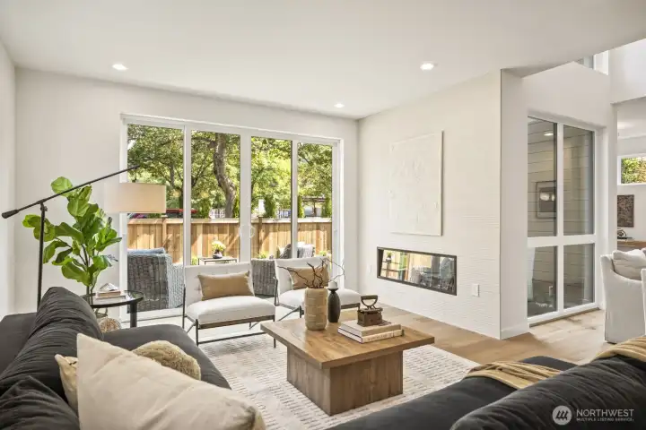 Gorgeous living room features electric fireplace feature, and double slider leading out to your private yard.  The perfect indoor/outdoor living