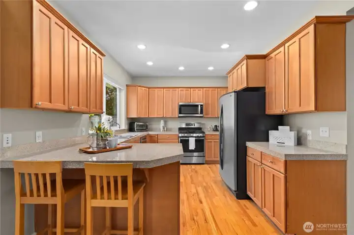 Well appointed chef's kitchen with granite counters and stainless steel appliances.
