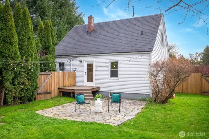 Fully fenced yard with great stone patio perfect for evening hosting.